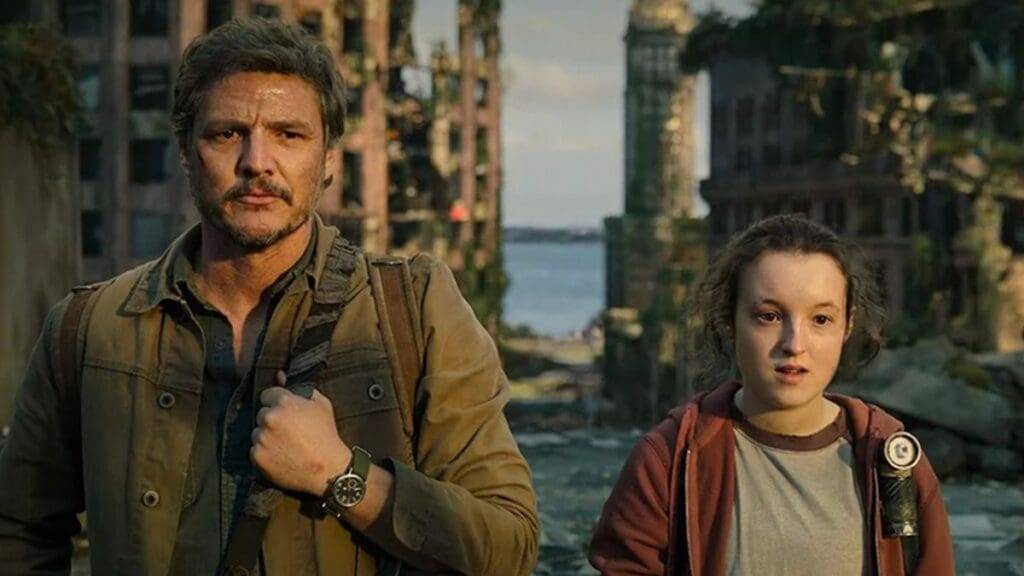 Pedro Pascal and Bella Ramsey standing together in a scene from a post-apocalyptic setting.