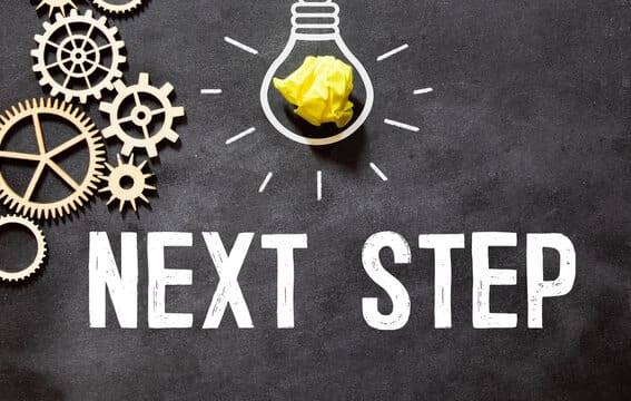 A light bulb graphic with a crumpled yellow paper and gears surrounding the text 'Next Step' on a dark background.