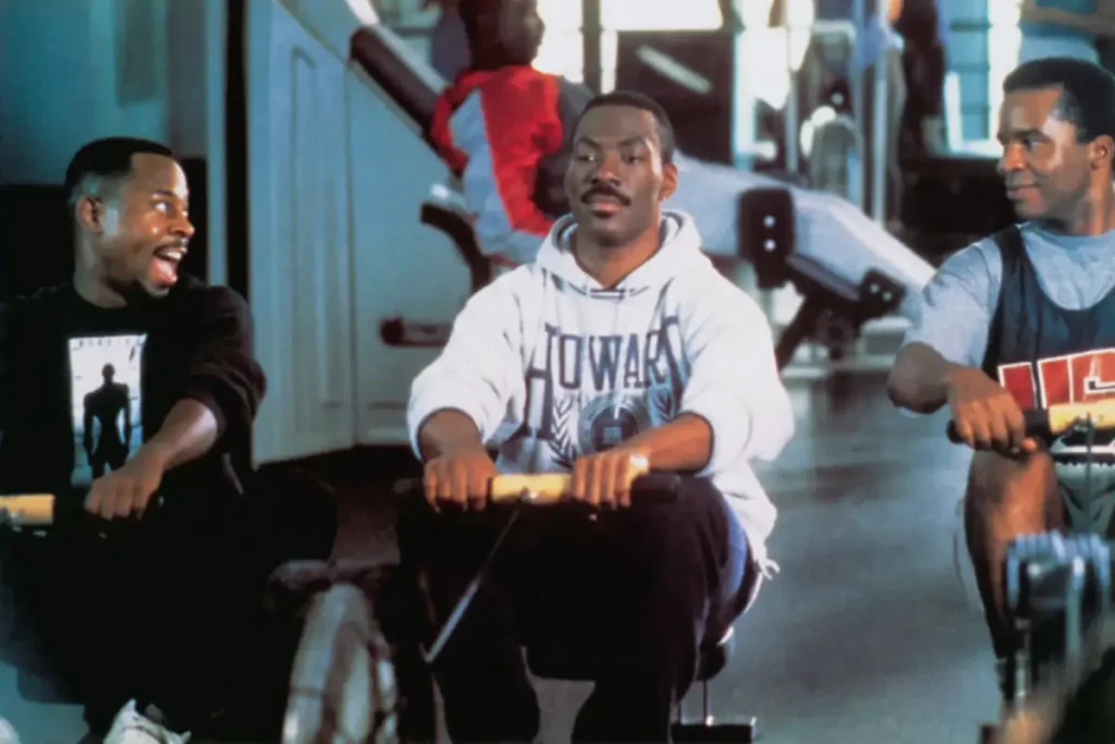 Three Men Rowing in a Gym Setting Three men sitting on rowing machines in a gym, engaged in exercise.