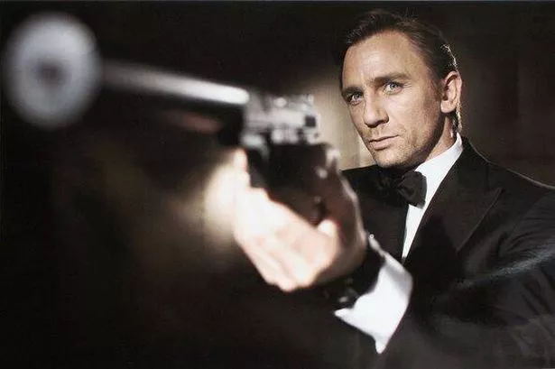 Daniel Craig holding a firearm while dressed in a tuxedo as James Bond in Casino Royale.