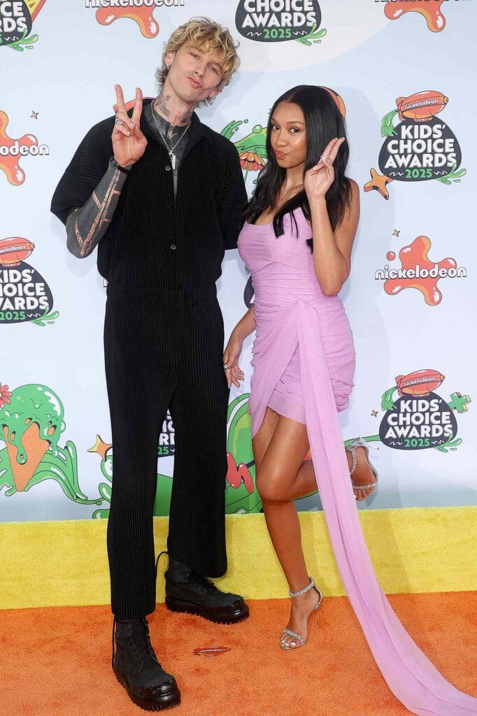 Machine Gun Kelly and Casie Baker posing together at the Nickelodeon Kids' Choice Awards 2025.