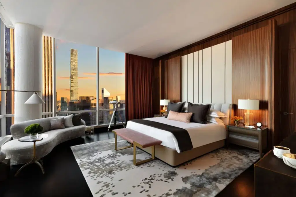 Master bedroom in the Park Hyatt New York Sky Suite featuring a large bed and modern furnishings.