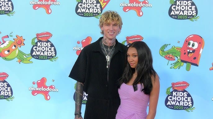 Machine Gun Kelly and Bernice Burgos posing together at the 2025 Kids' Choice Awards event.