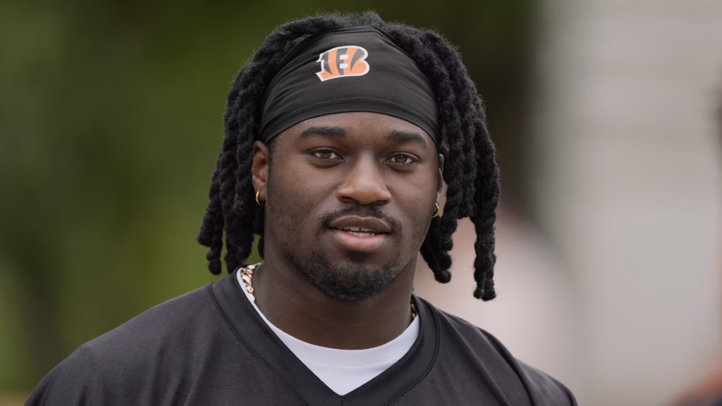 Football player wearing a black jersey and headband with the Cincinnati Bengals logo.