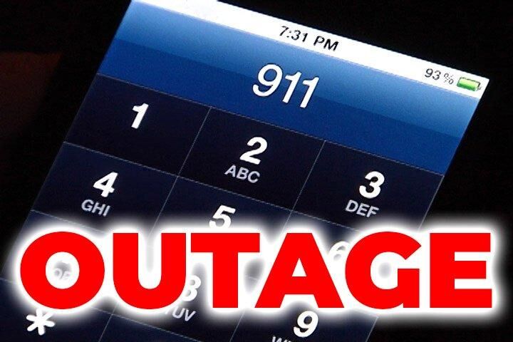 Close-up of a smartphone screen displaying the emergency call interface with the word 'OUTAGE' in bold red letters.