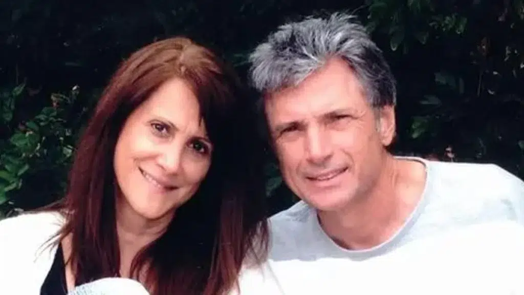 A man and woman posing together for a portrait with smiles on their faces.