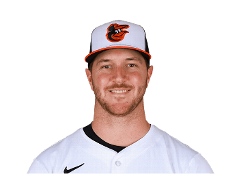 Portrait of a baseball player wearing an orange and black cap with an Orioles logo and a white jersey.
