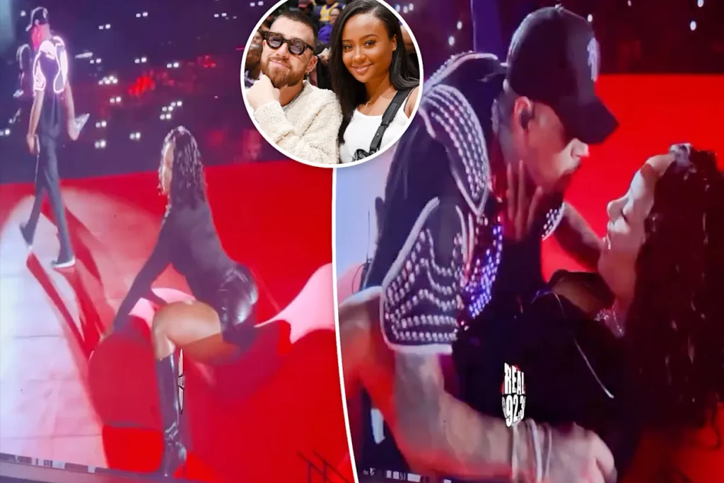 A performer on stage interacting with a dancer during a live performance.