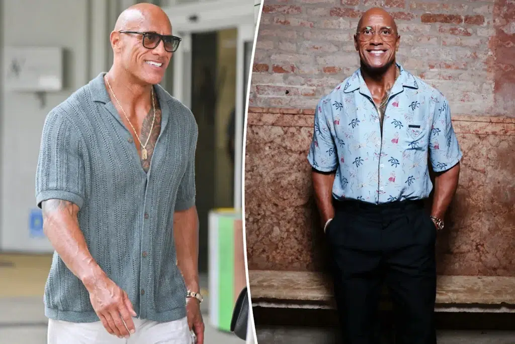 Dwayne Johnson wearing a short-sleeve button-up shirt and sunglasses, smiling at the camera.