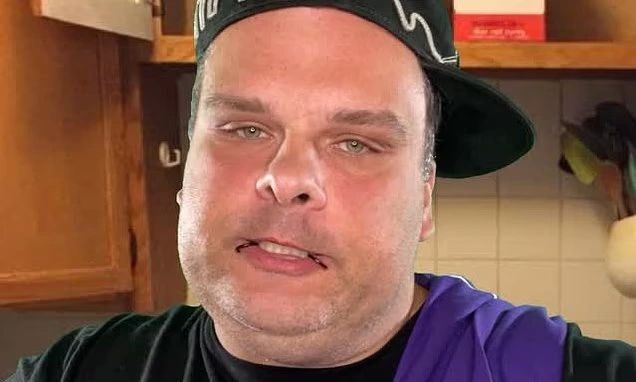 Portrait of comedian Steve Bridges wearing a cap and a purple shirt.