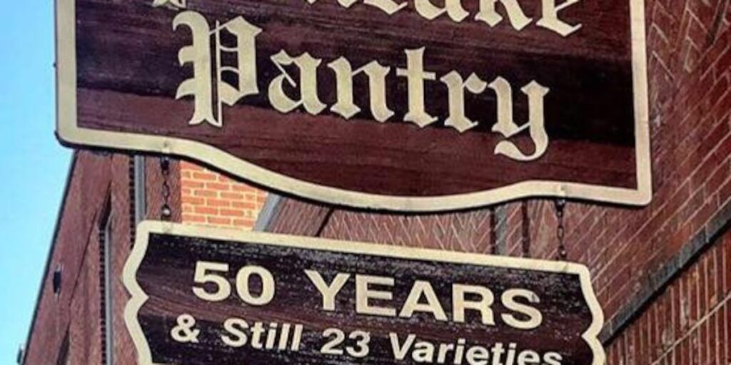 Wooden sign for a bakery pantry stating '50 Years & Still 23 Varieties'.