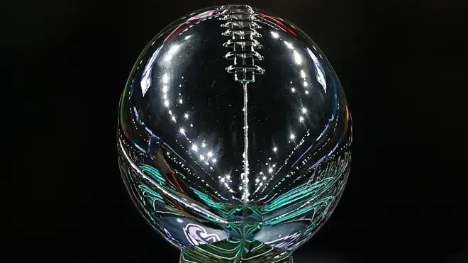 Reflection of the Lombardi Trophy showcasing its distinct shape and shine.